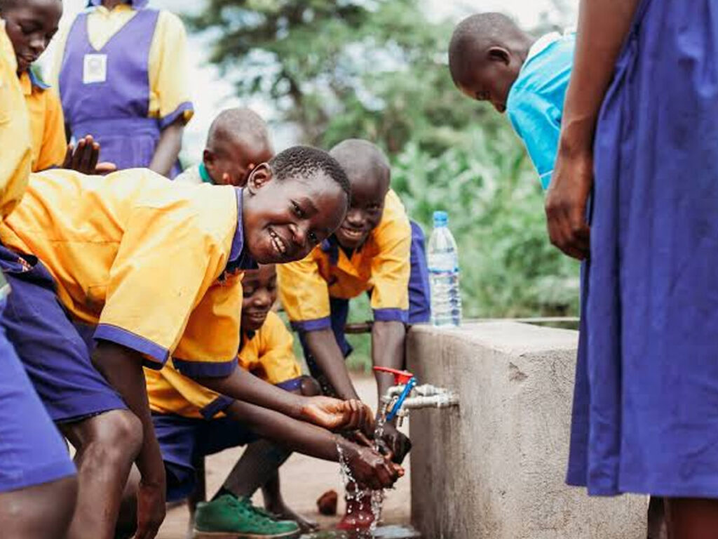 Children washing their hands at a water point
